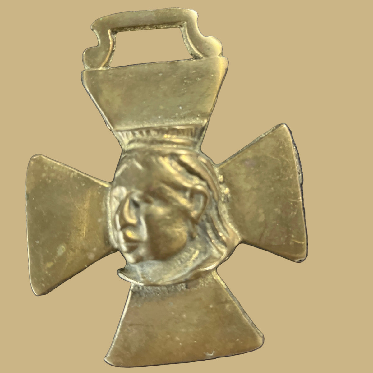 A Victorian horse brass featuring a relief of Queen Victoria.
