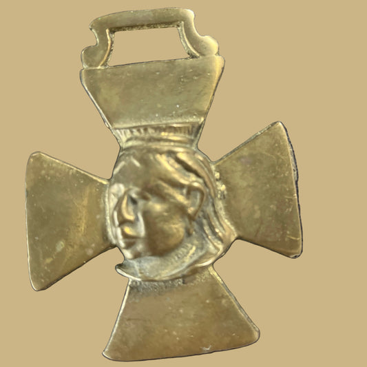 A Victorian horse brass featuring a relief of Queen Victoria.